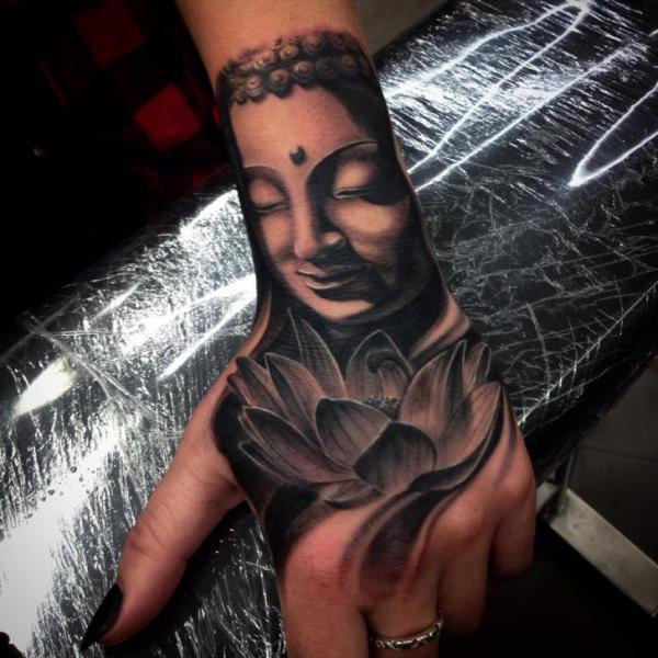Buddhas Hand in bronze tattooed on the upper arm