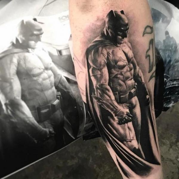 Realistic style Batman tattoo on the left upper arm and